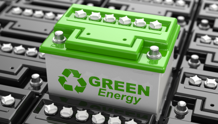 A bright green battery labeled “Green Energy” stands out among black batteries, highlighting the evolving technology of Smart Meters in UK.