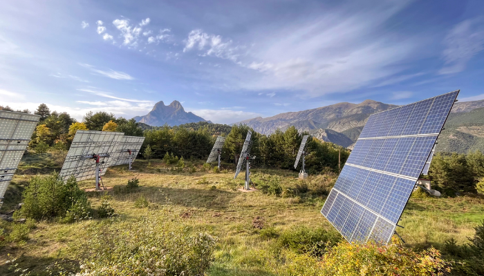 Solar panels installed in a mountainous landscape, representing the renewable energy infrastructure that works in tandem with US Smart Meters for efficient power management.