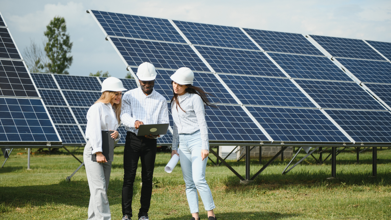 A professional team reviews plans beside a rooftop solar array. Their corporate attire and collaborative stance reflect strategic planning and design choices between photovoltaic and thermal applications in urban environments.