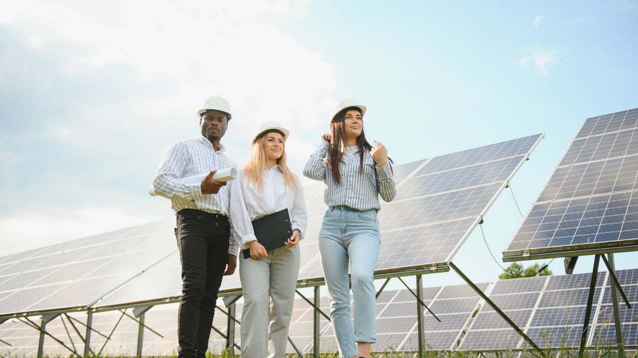Three engineers in hard hats walk alongside solar panels, inspecting their layout. "Orientation and tilt" highlights the professional evaluation of solar panel angles for optimized energy efficiency.