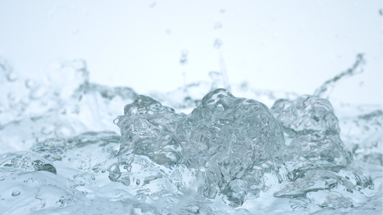 The image highlights the dynamic force of microhydro, as water surges upward in a burst of energy and clarity.